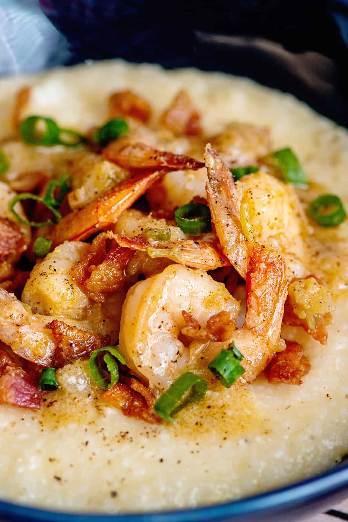 Close-up of shrimp and grits with green onions as a garnish.