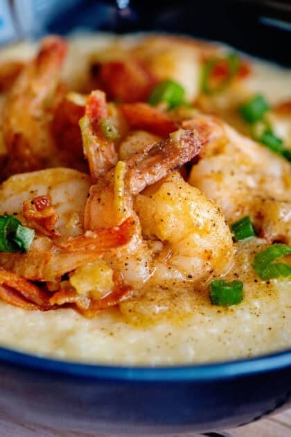 Close-up of shrimp and grits with green onions as a garnish.