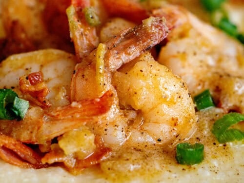 Close-up of shrimp and grits with green onions as a garnish.
