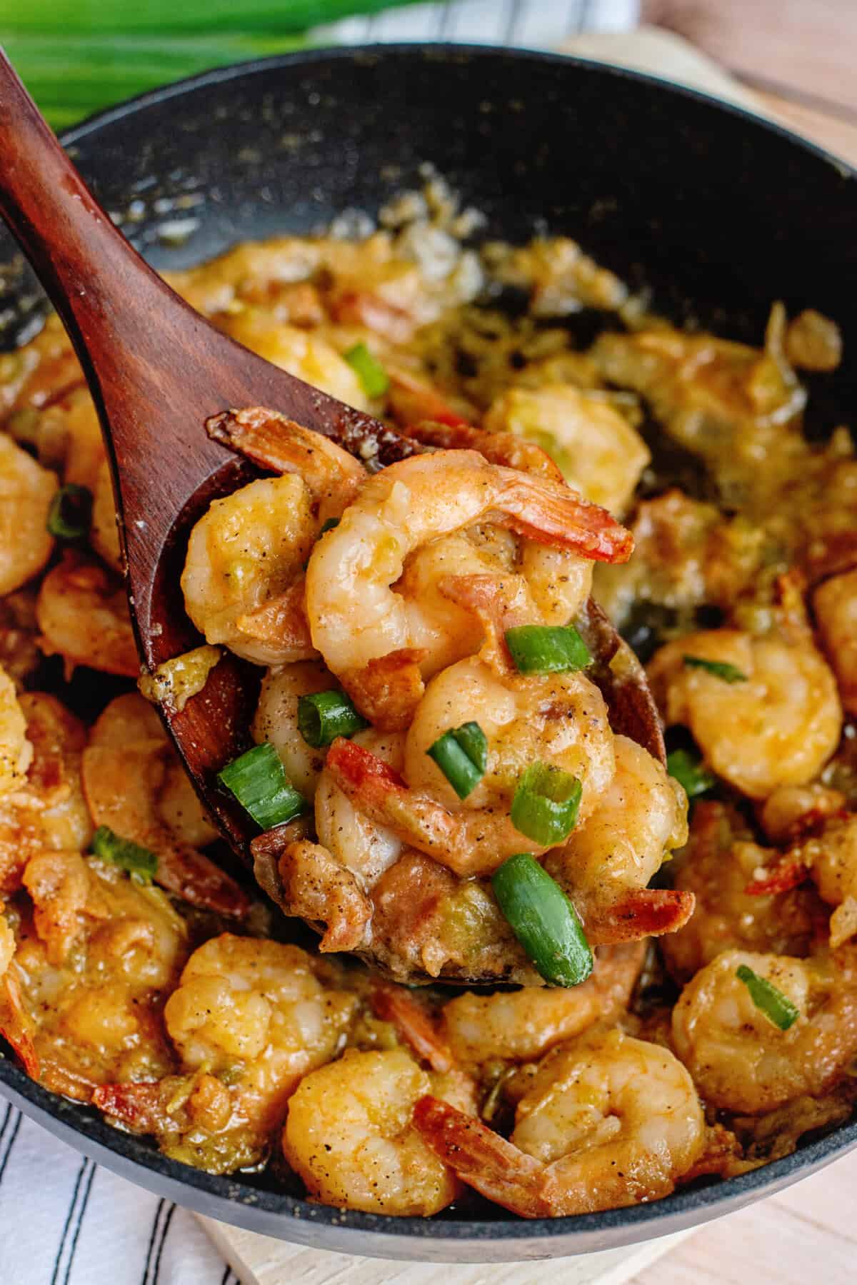 Freshly chopped green onions sprinkled over a steaming bowl of Southern shrimp and grits for a pop of color.