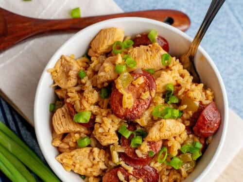 Rich, flavorful jambalaya with andouille, chicken, and rice in a white serving bowl.