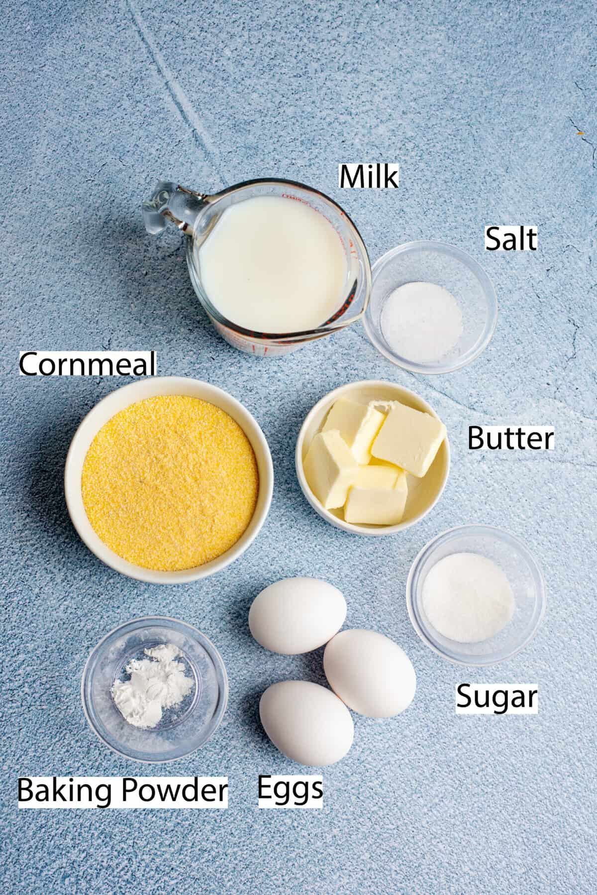 Ingredients for Southern spoonbread recipe on a blue counter top.