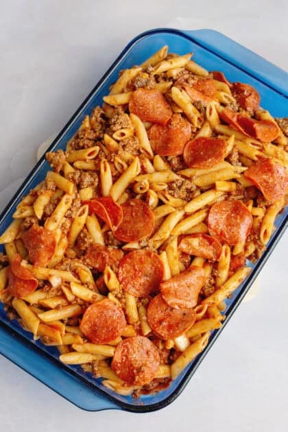 Pizza pasta casserole in a baking dish before adding cheese.