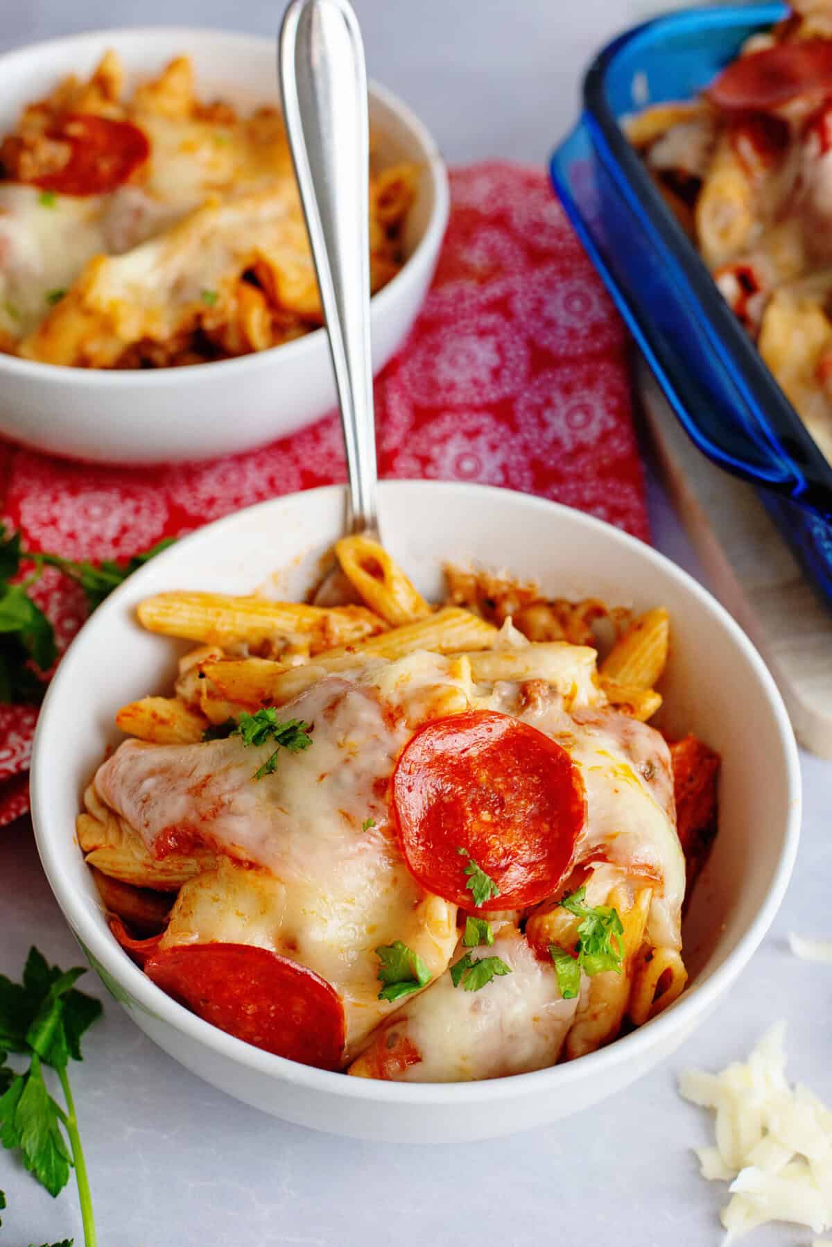 A white bowl of pizza pasta casserole.