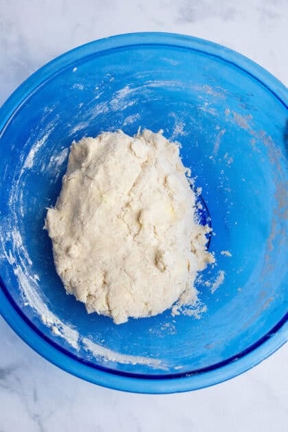 Biscuit dough in a blue bowl.