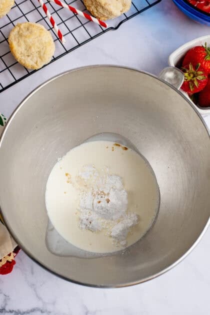 Ingredients for whipped cream in a mixing bowl.