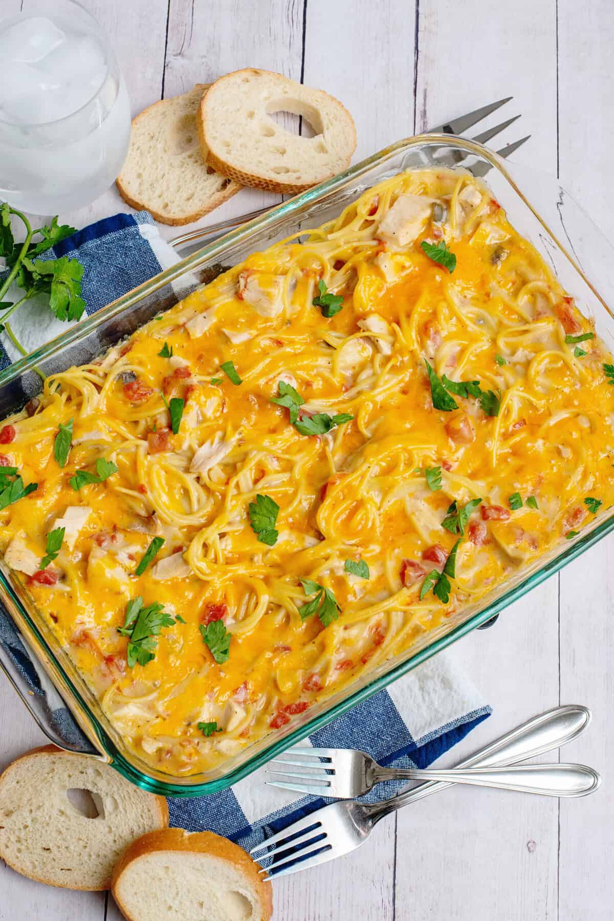 Cheesy chicken spaghetti in a casserole dish.