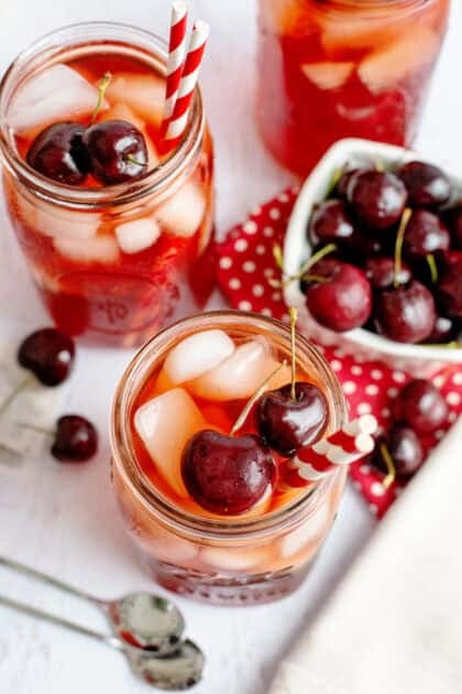 2 glasses of iced cherry apple tea with cherries