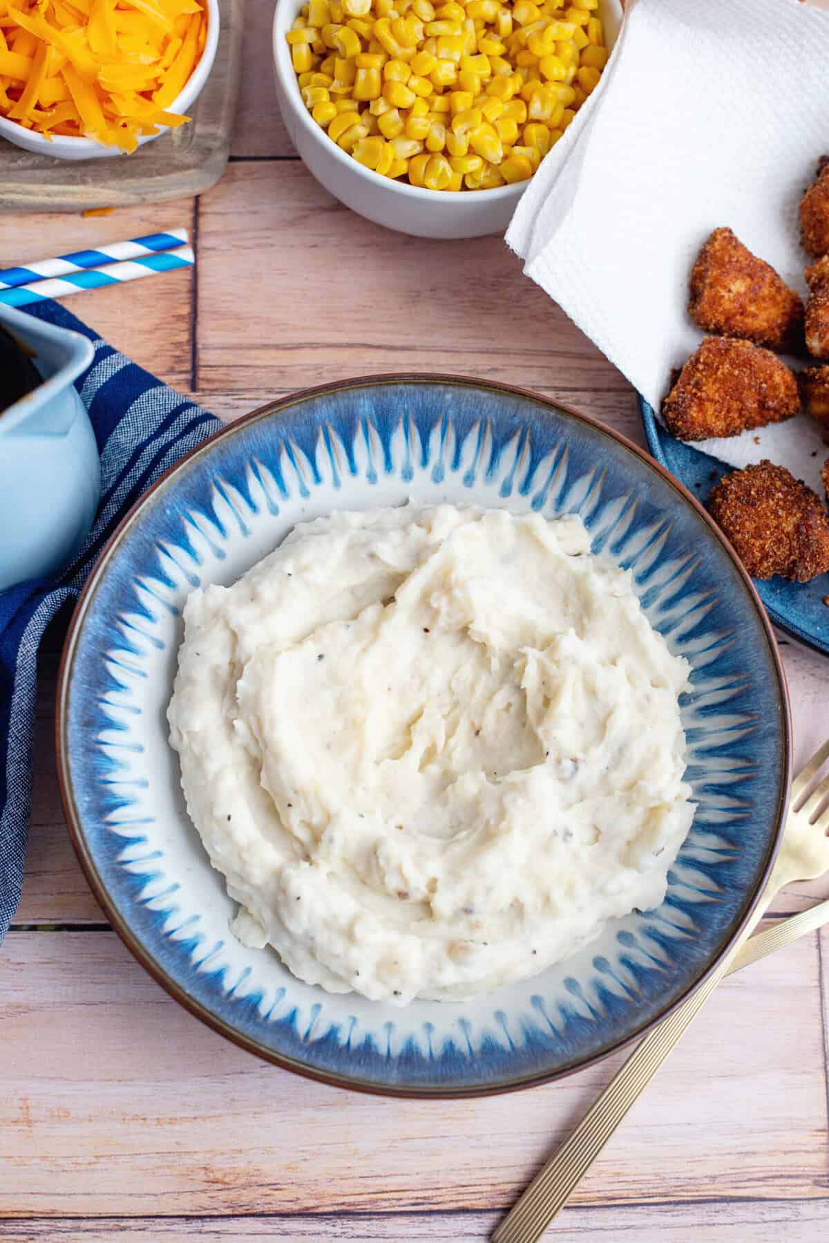 Fluffy mashed potatoes in a decorative bowl.