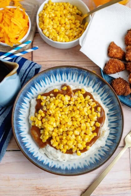 Homemade KFC bowls layered with potato, gravy, and corn.