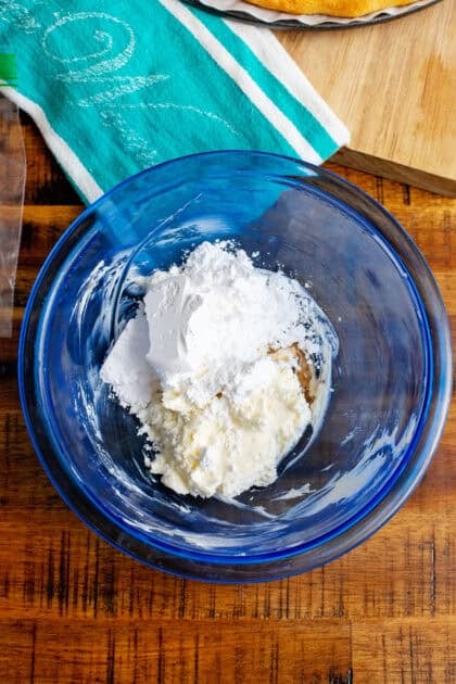 Mixing ingredients to make a cream cheese icing.