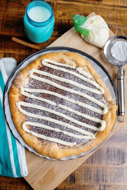 Cinnamon sugar dessert pizza with a cream cheese glaze.