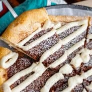 A spatula taking a slice of dessert pizza from the pizza pan.