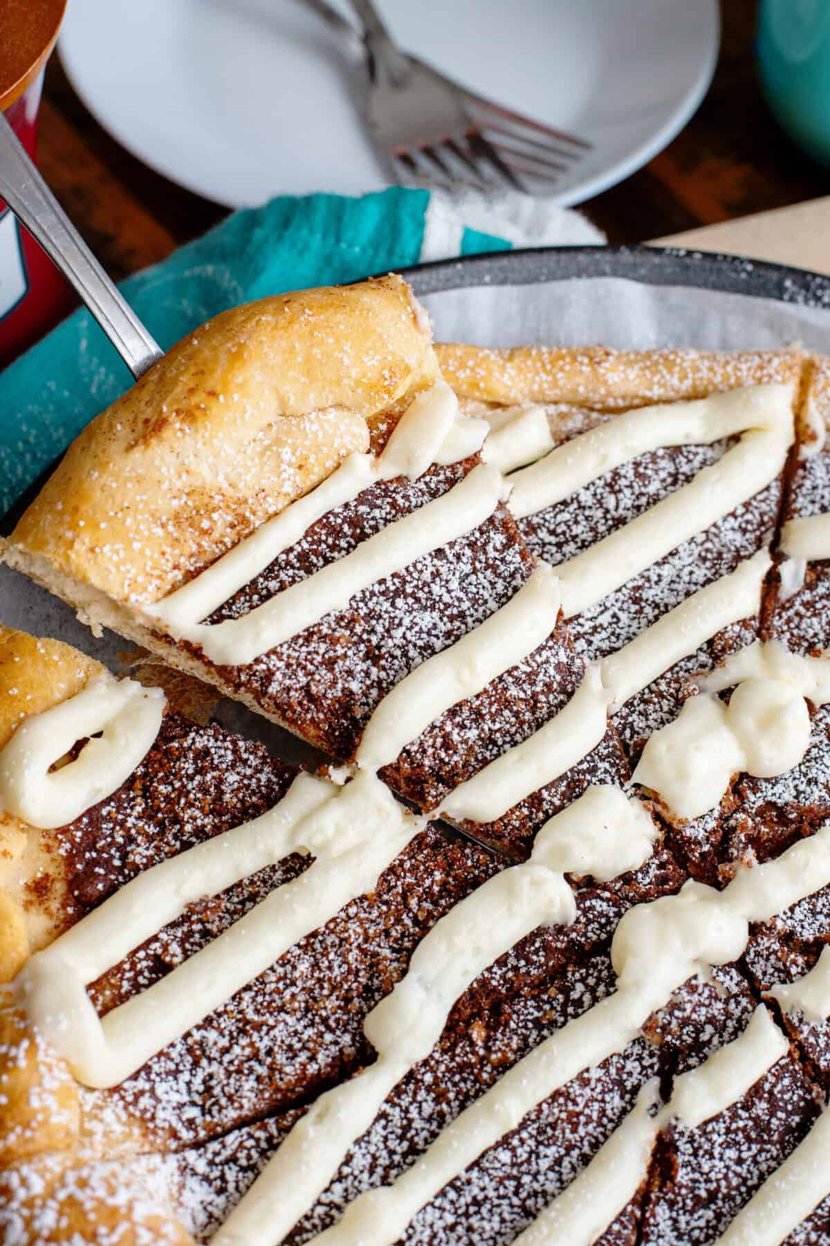 A spatula taking a slice of dessert pizza from the pizza pan.