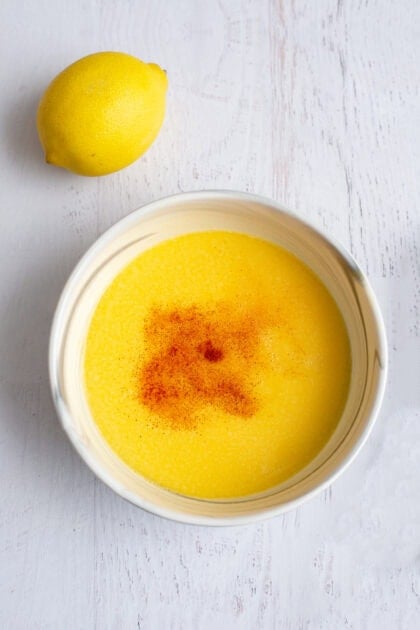 Bowl of whisked egg yolks for hollandaise sauce with paprika