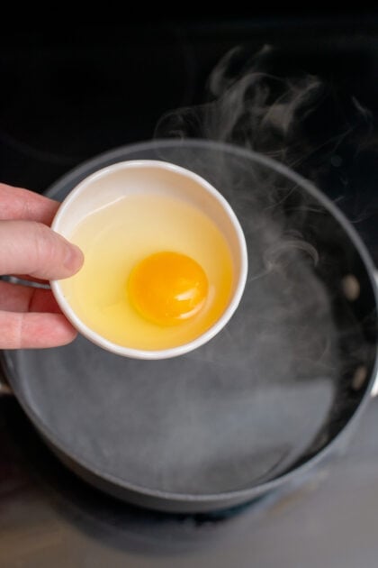 Placing egg into the center of simmering water