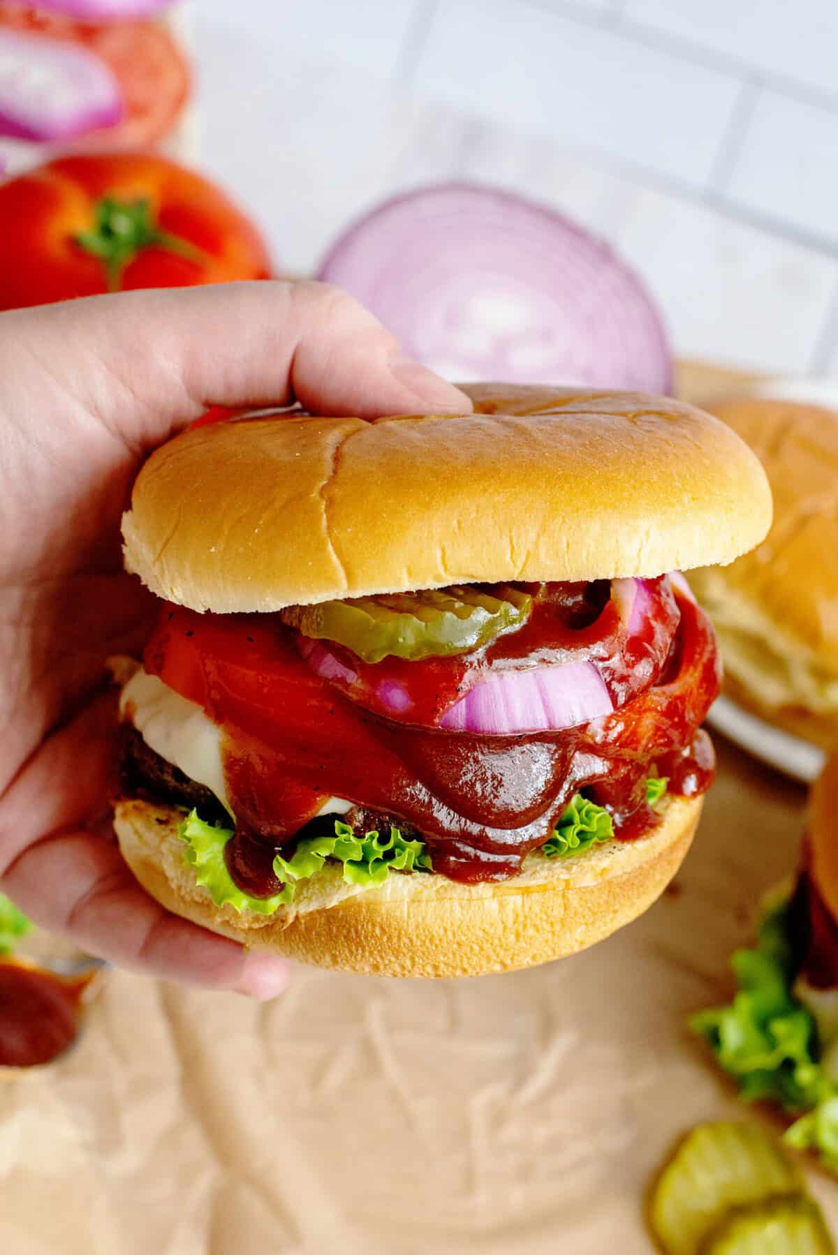 Person holding assembled southern grilled cheeseburger