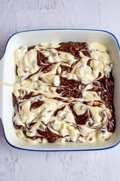 Creating a marble effect with the brownie and cheesecake mixtures