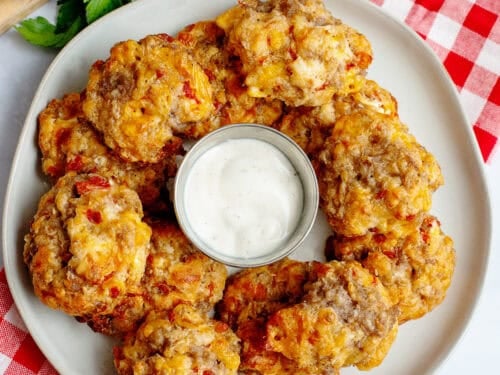 Rotel cream cheese sausage balls on a plate with dipping sauce