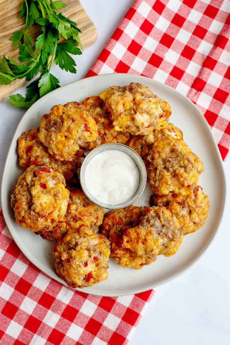 Rotel cream cheese sausage balls on a plate with dipping sauce