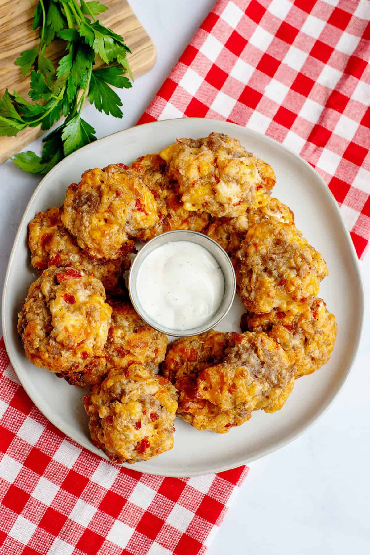 Rotel cream cheese sausage balls on a plate with dipping sauce