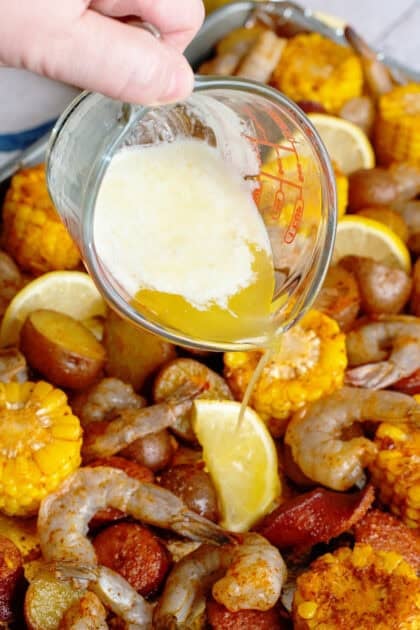 Melted butter being drizzled on seafood boil