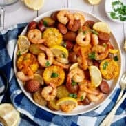 Sheet pan low country seafood boil plated serving next to ingredients