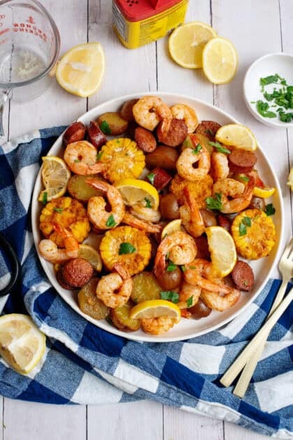 Sheet pan low country seafood boil plated serving next to ingredients