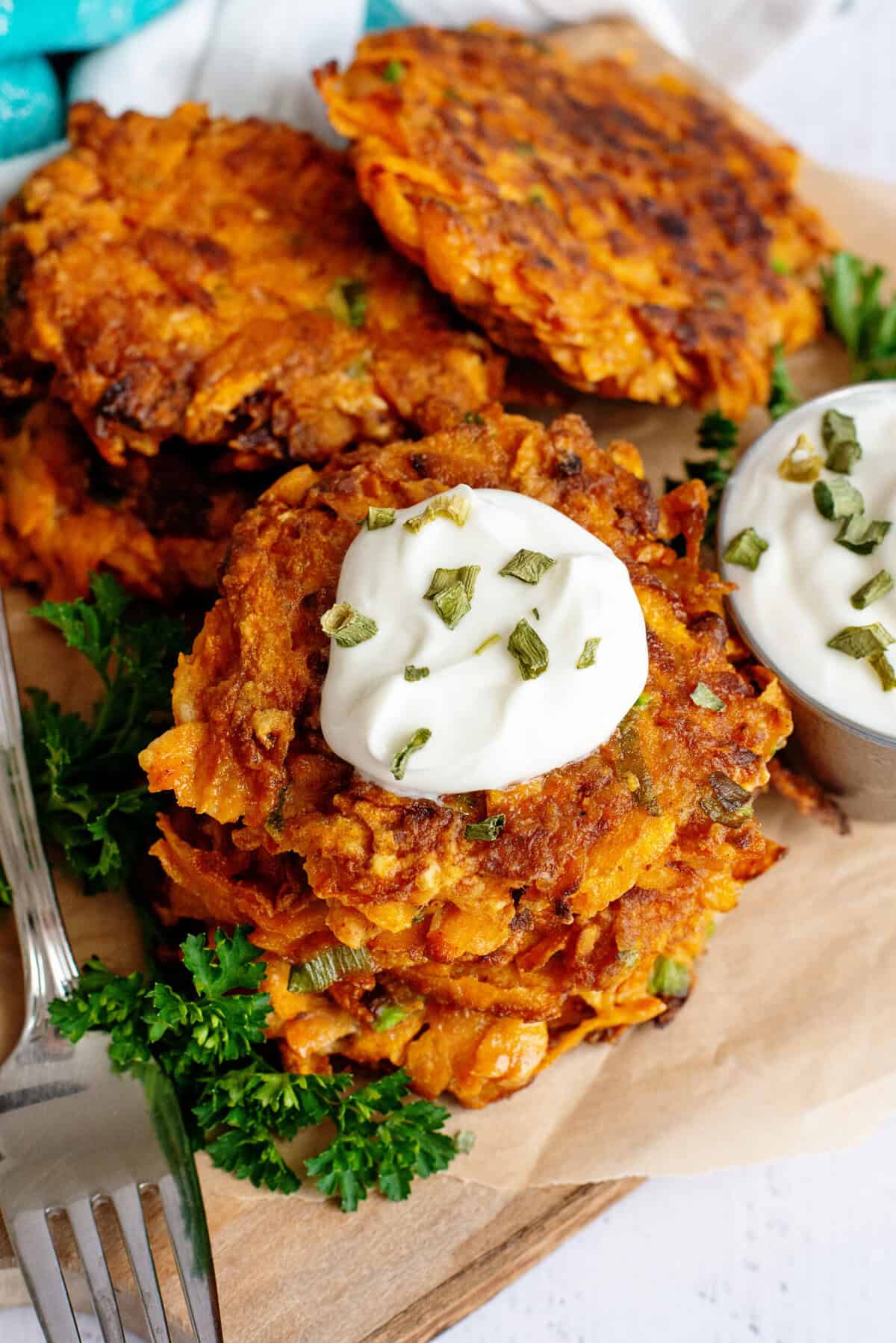 Sweet potato fritters topped with sour cream.