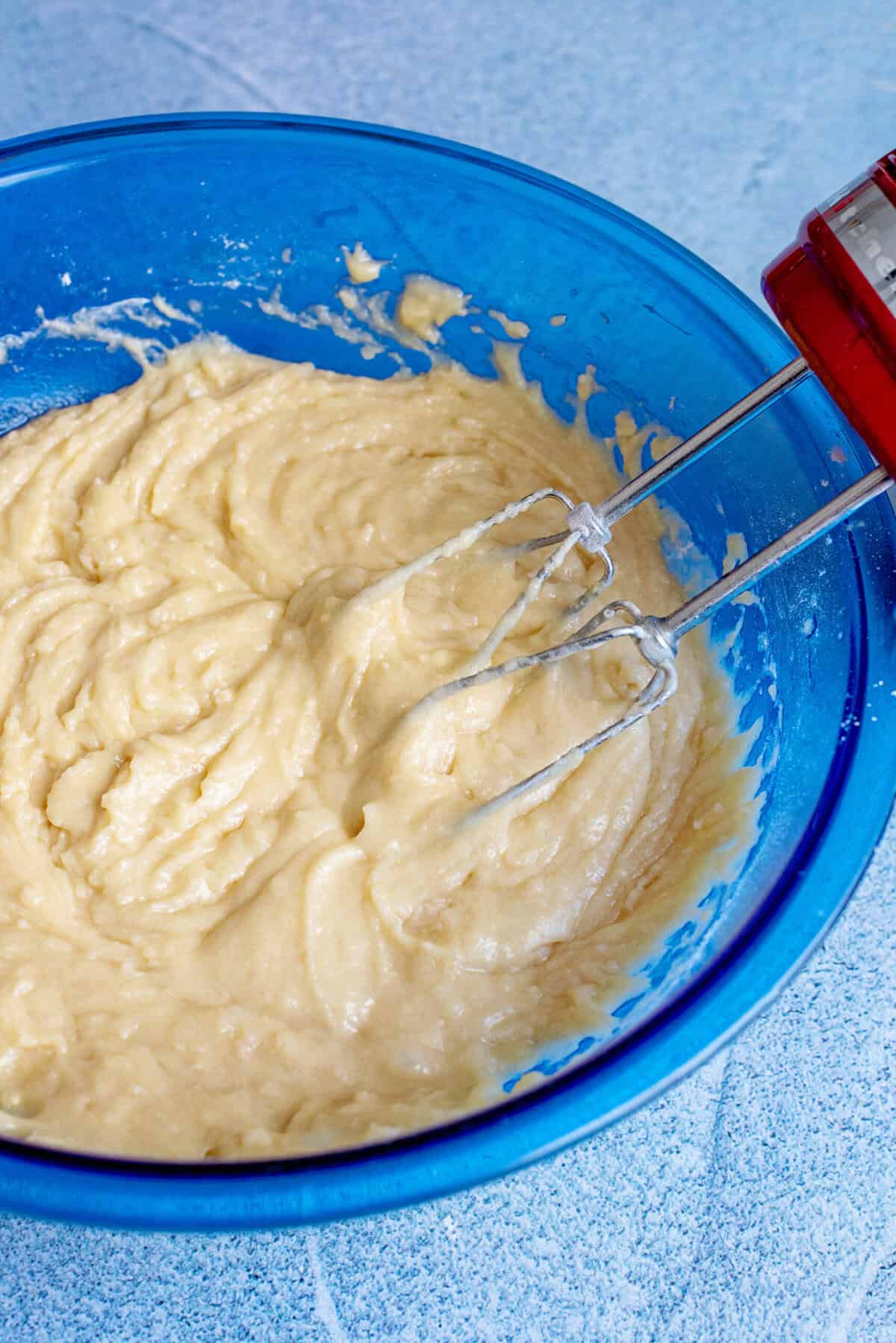Apple pound cake batter mixed together in a bowl