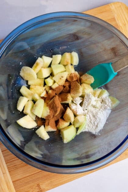 Bowl of peeled apples with spices