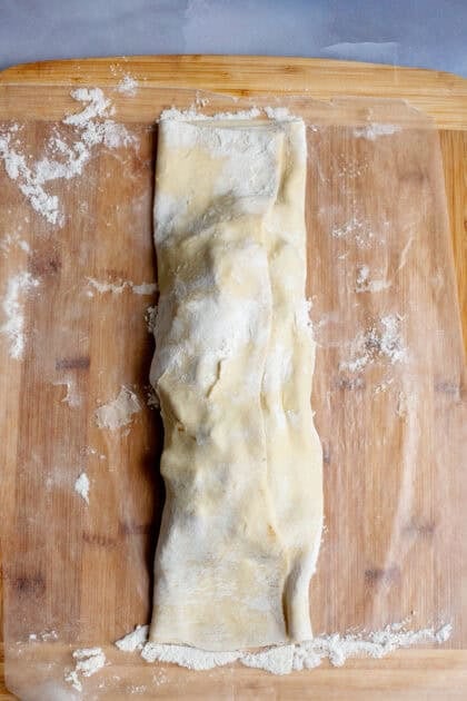 Folded apple strudel dough with filling inside