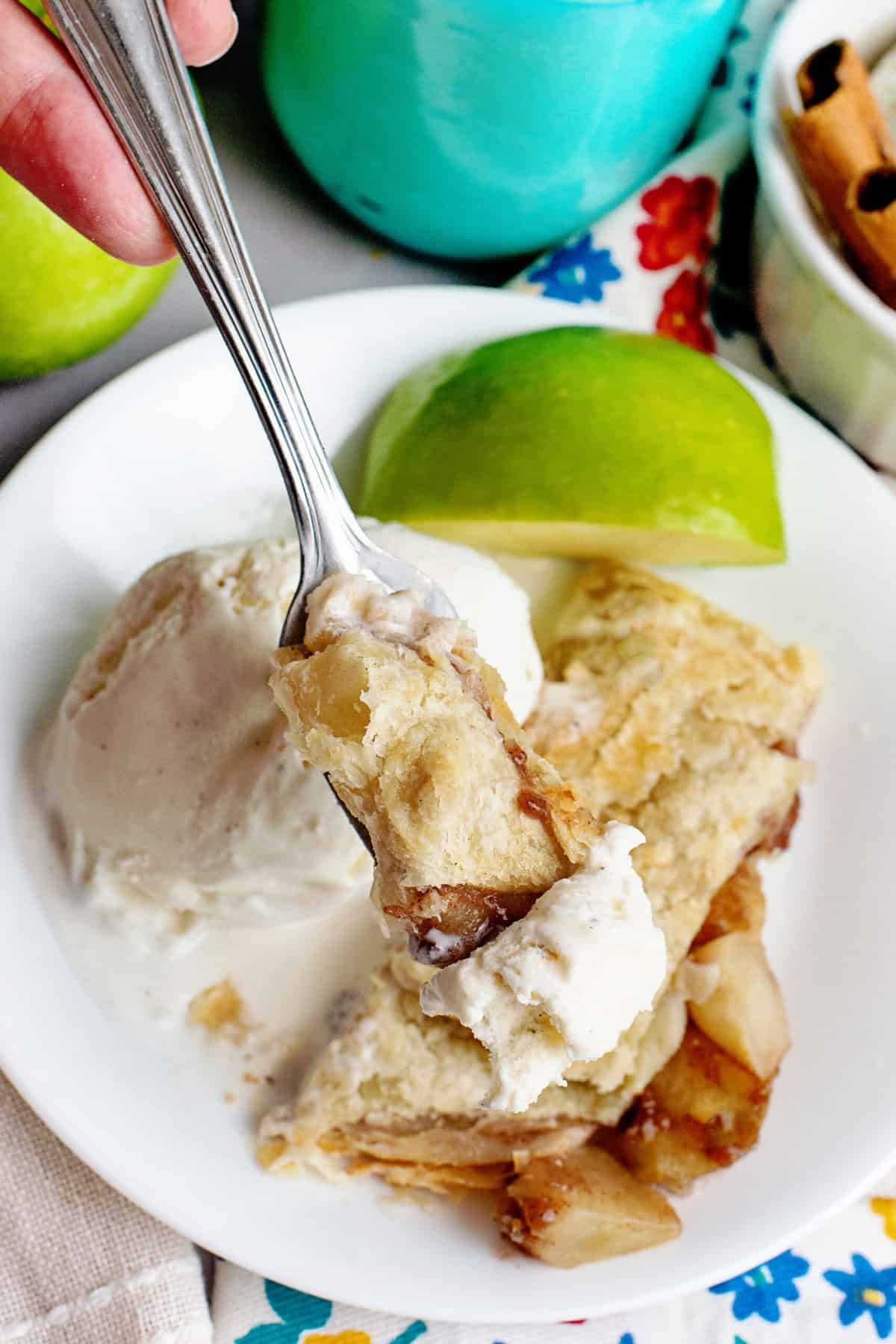 A serving of apple strudel with vanilla ice cream and an apple slice