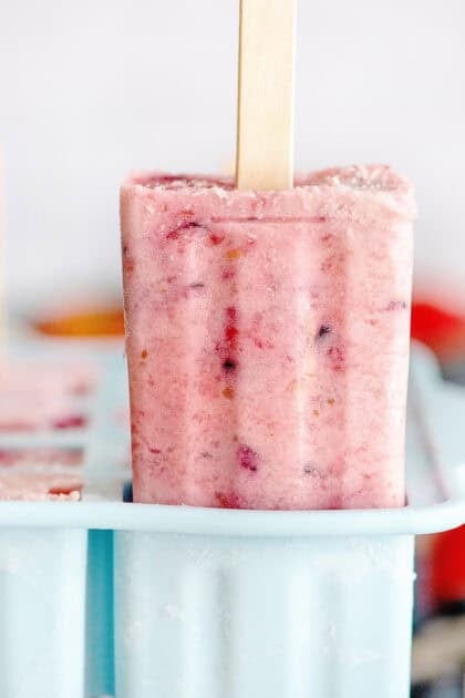 Sliding a berries and cream popsicle from the mold