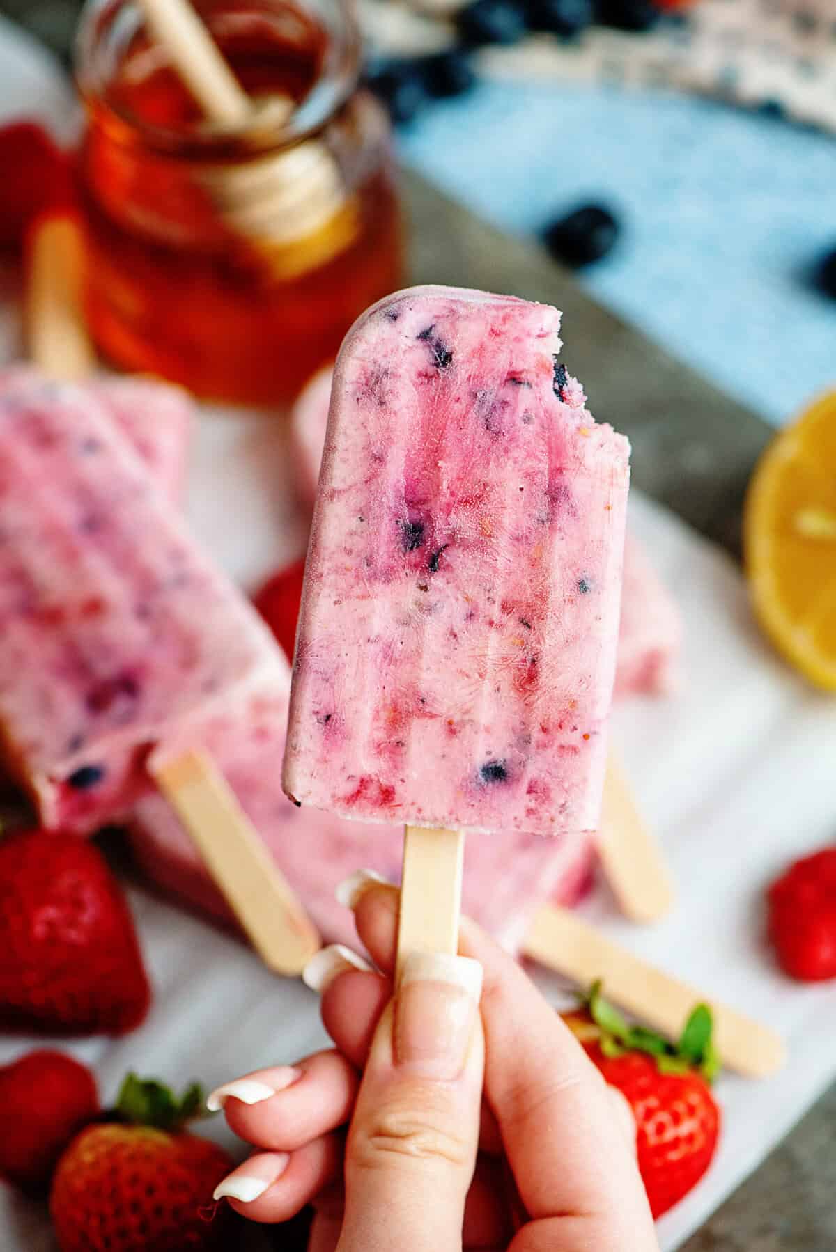 berries and cream popsicle with a bite taken out
