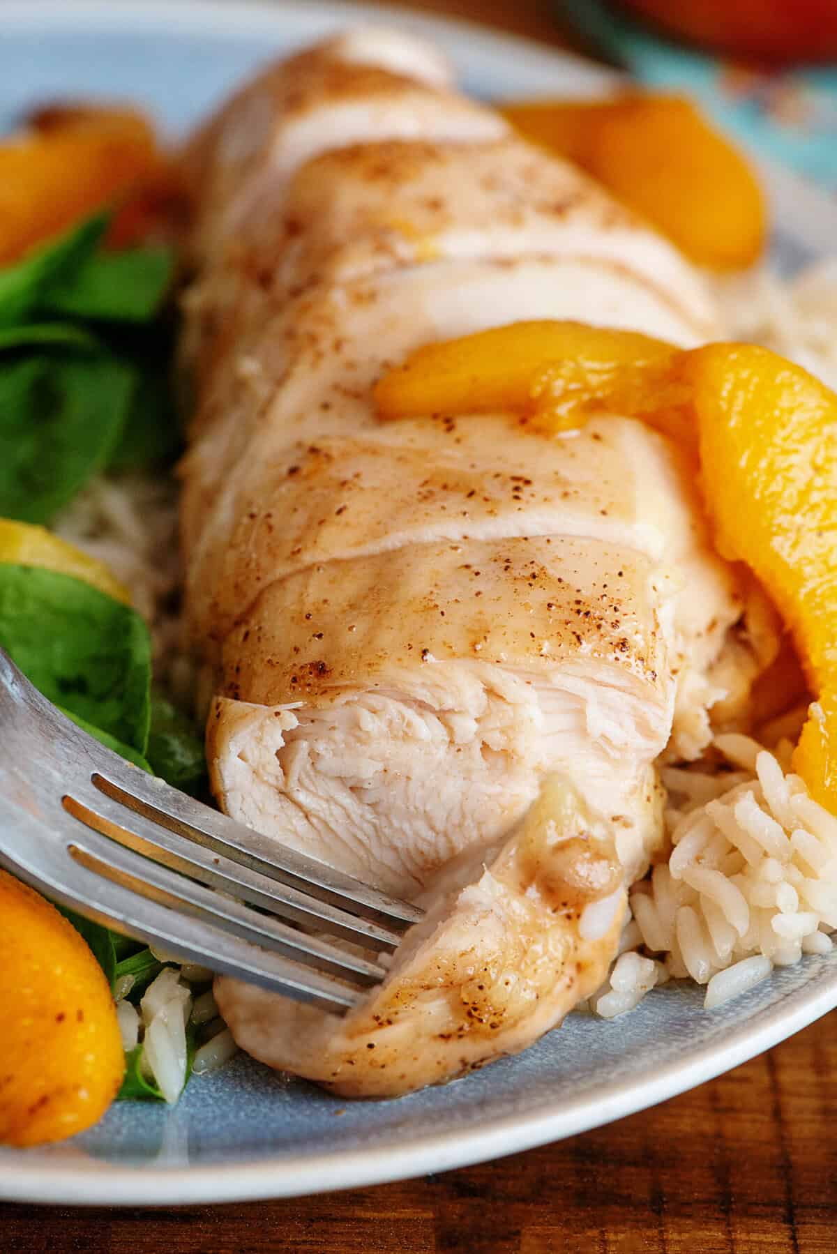 A plate of ginger baked chicken and a fork 