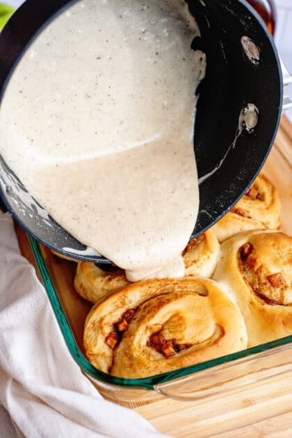 Drizzling apple cinnamon rolls with brown butter maple icing