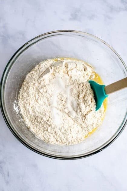 Flour and salt in a mixing bowl with other apple cinnamon roll ingredients