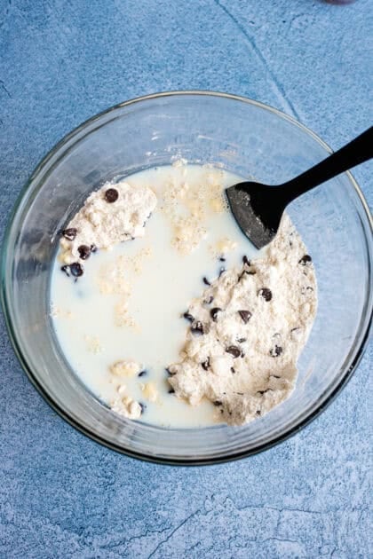 Stirring all of the chocolate chip biscuit ingredients together