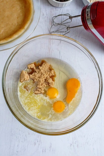 Large bowl with eggs, brown sugar, and corn syrup