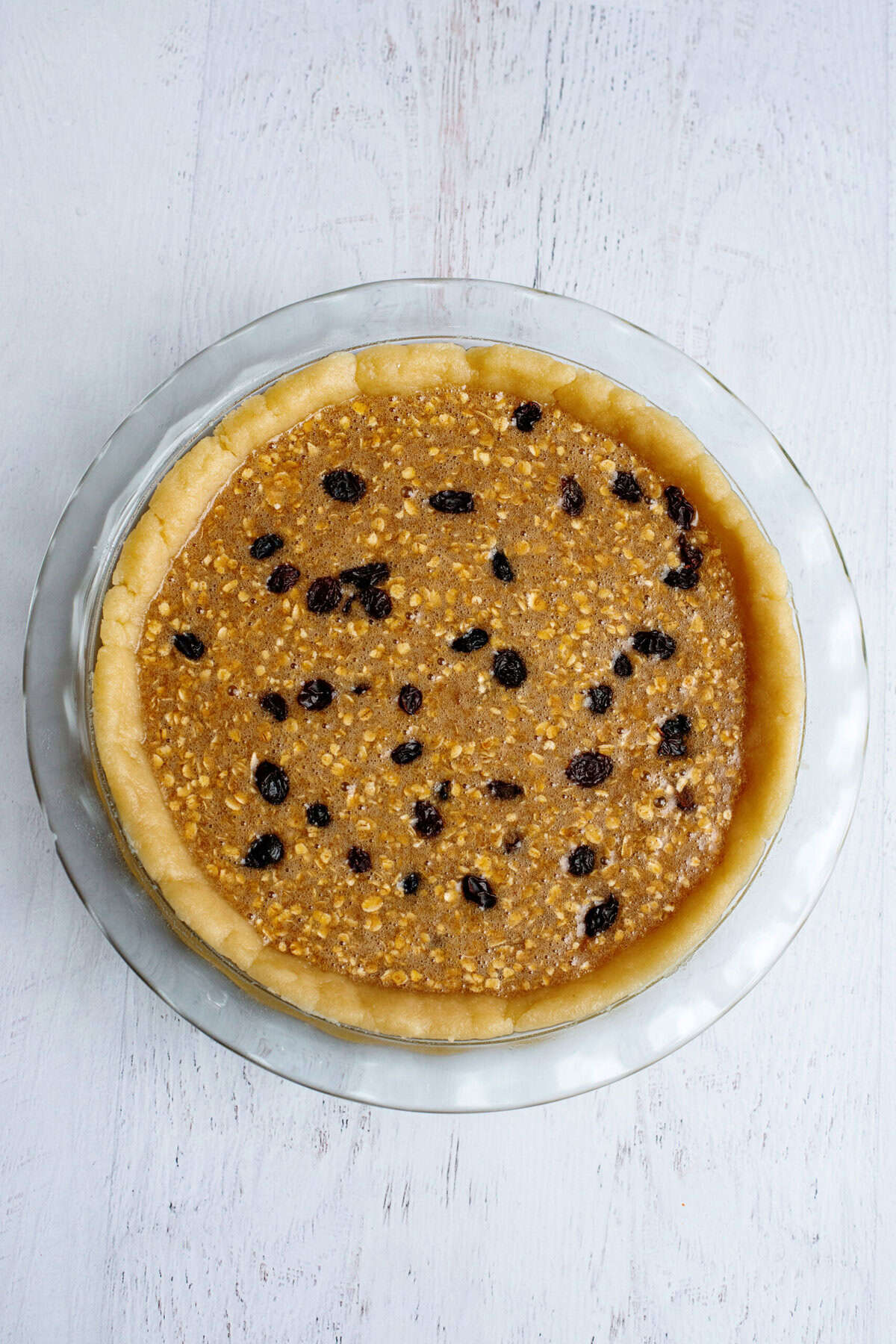 Unbaked oatmeal raisin cookie pie batter in crust