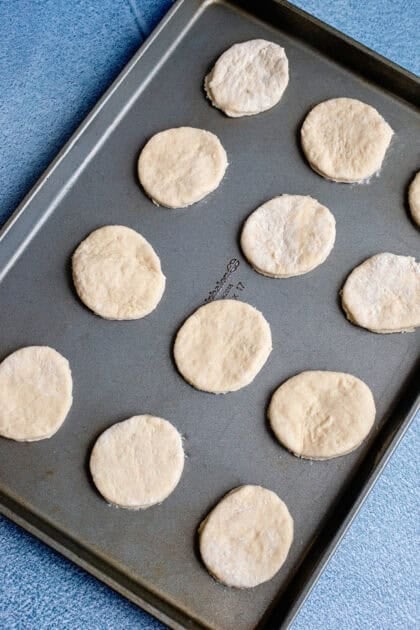 Raw easy homemade biscuits lined up on a baking sheet
