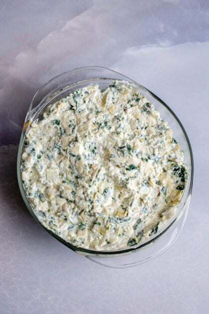 A bowl of mixed spinach artichoke dip base