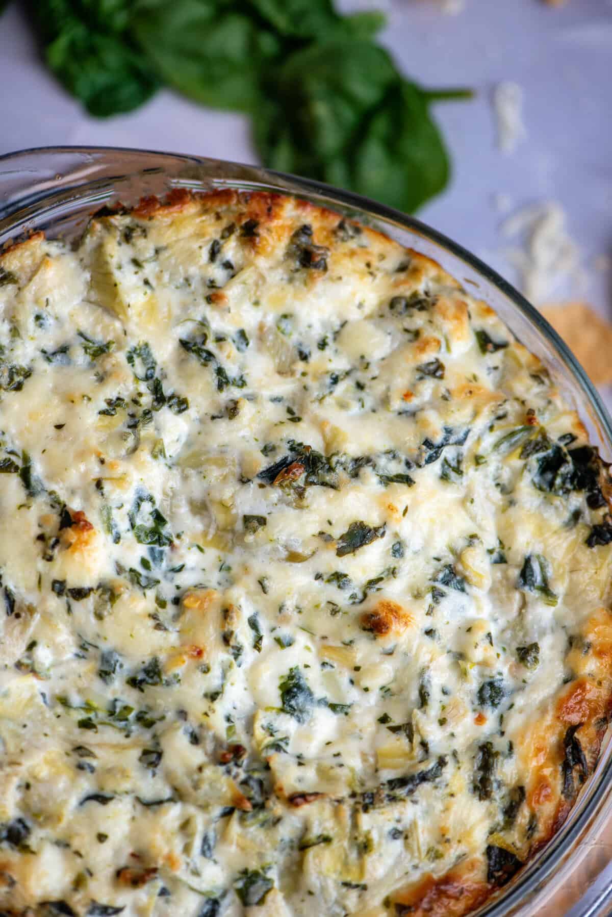 A baked bowl of spinach artichoke dip