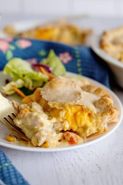 Plated cheesy chicken pot pie with salad