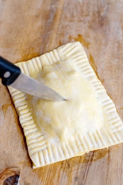 Cutting vents on the tops of the handheld chicken pot pies
