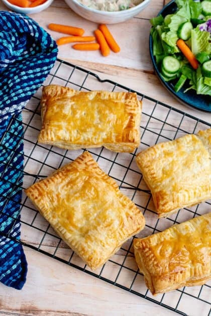 Baked handheld chicken pot pies cooling on a wire rack