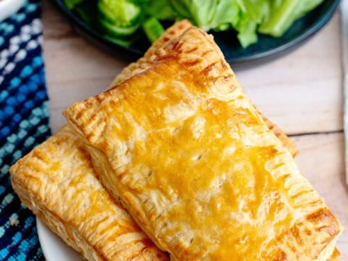 A plate of two handheld chicken pot pies