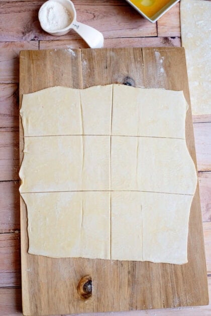 Cut and rolled out puff pastry on a floured surface