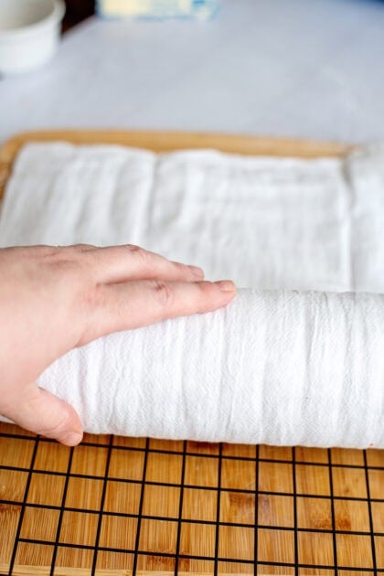 Rolling the pumpkin roll with a towel